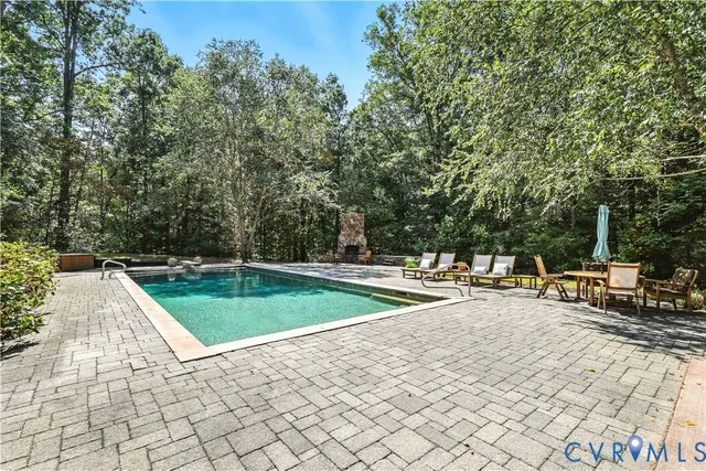 a backyard of a house with barbeque oven and outdoor seating