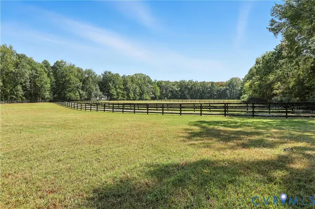 a front view of a house with yard and tree