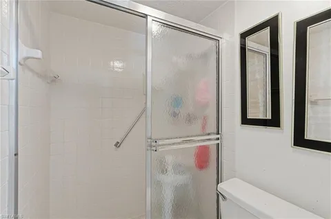 a bathroom with a shower and a toilet