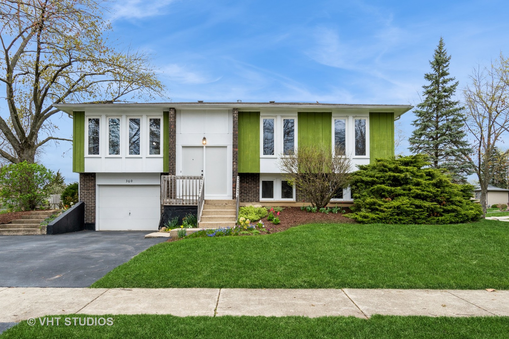 360 Galahad Road Bolingbrook, IL 60440 - Photo 1 of 20 a front view of a house with a yard and garage
