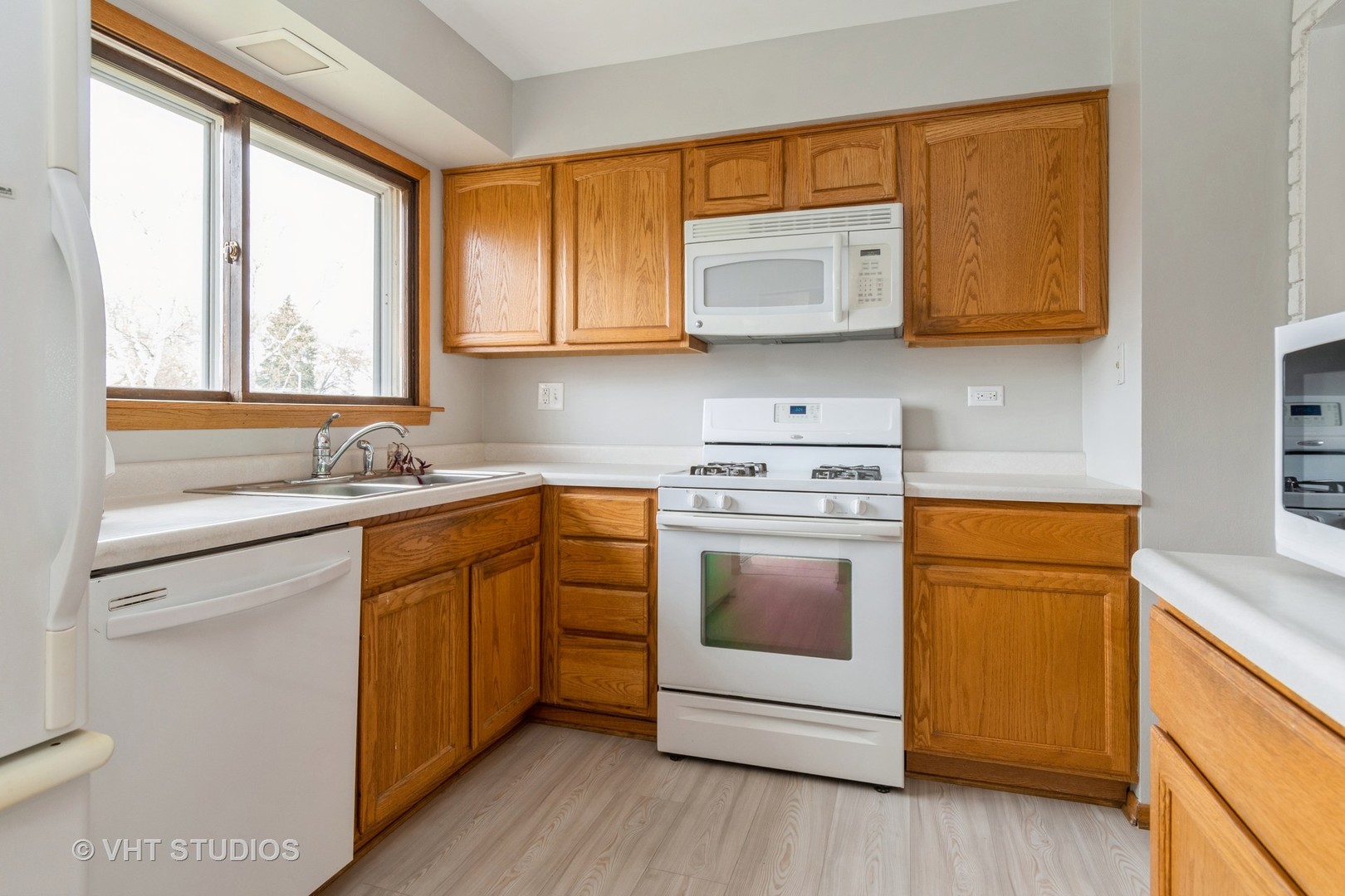 360 Galahad Road Bolingbrook, IL 60440 - Photo 5 of 20 a kitchen with stainless steel appliances granite countertop a stove a sink and a microwave