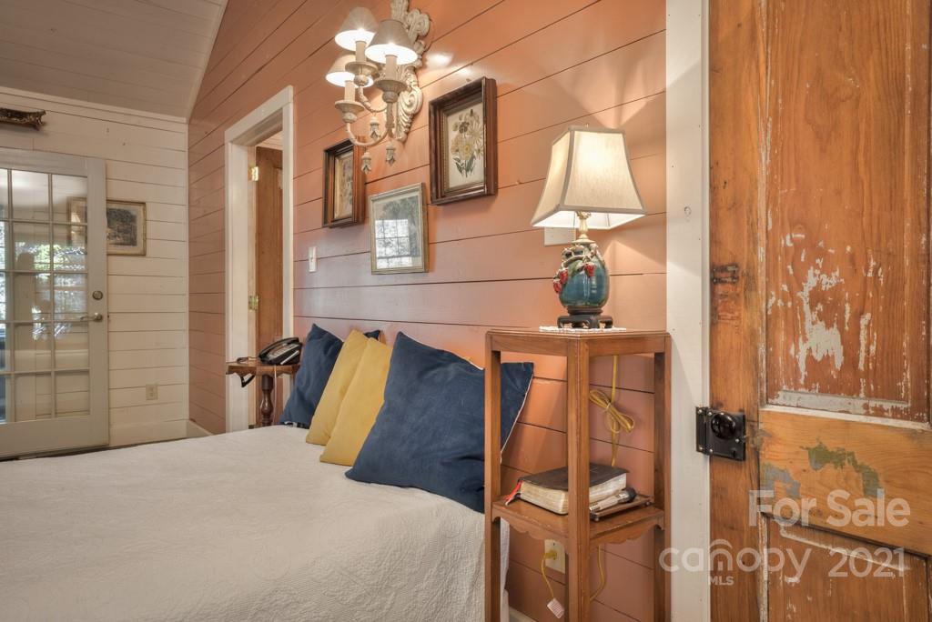 315 North Campbell Road Landrum, SC 29356 - Photo 31 of 40 a bedroom with a bed and a chandelier
