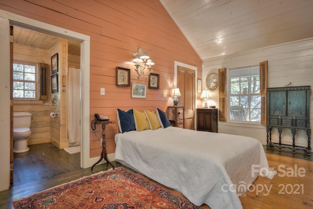 315 North Campbell Road Landrum, SC 29356 - Photo 32 of 40 a large bedroom with a bed and wooden floor