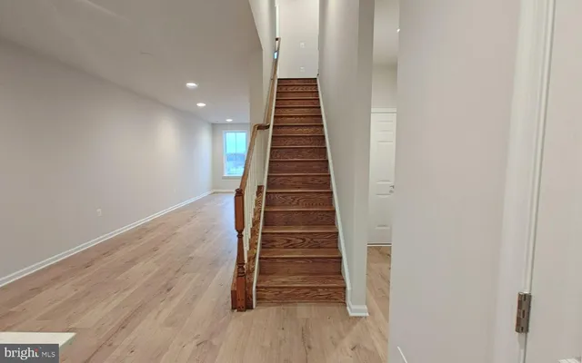 a view of entryway and hall with wooden floor