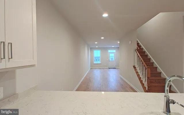 a view of livingroom and hall with wooden floor
