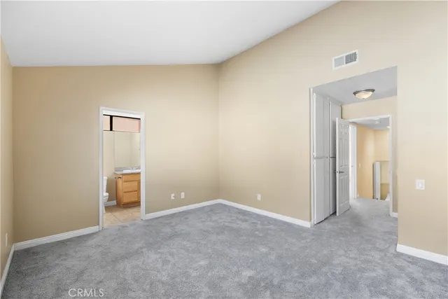 an empty room with an entryway and an empty room