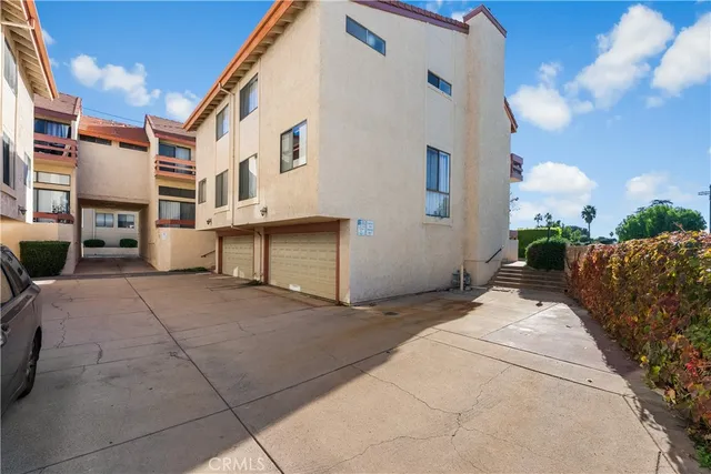 a view of balcony with two chairs and potted plants