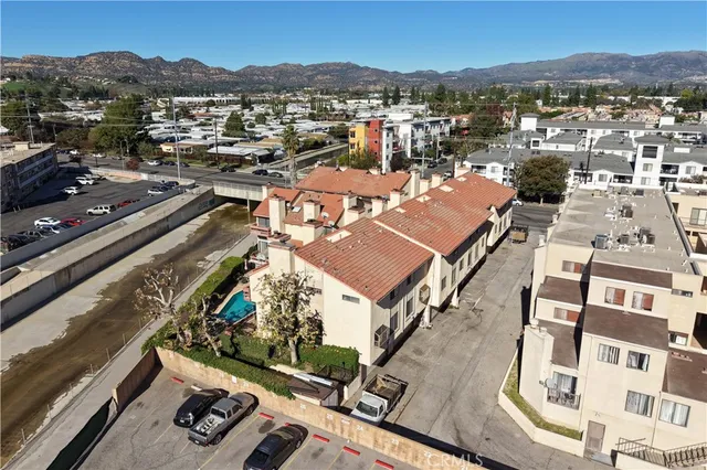 an aerial view of residential houses with city view