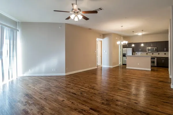 a view of a kitchen with a dishwasher cabinets and wooden floor