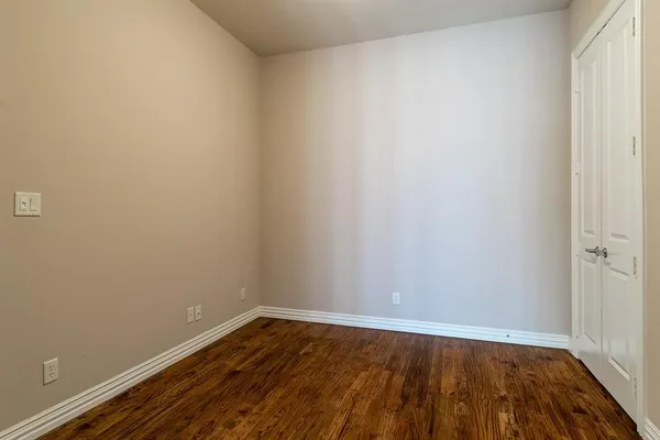 a view of an empty room and wooden floor