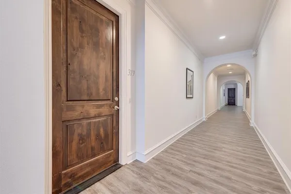 a view of a hallway with wooden floor