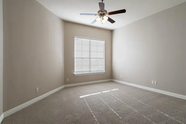 a view of room with a ceiling fan and window