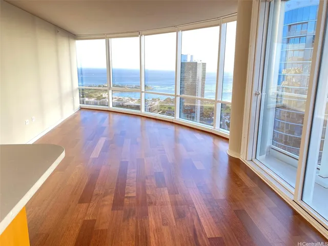 a view of a room with wooden floor and a floor to ceiling window