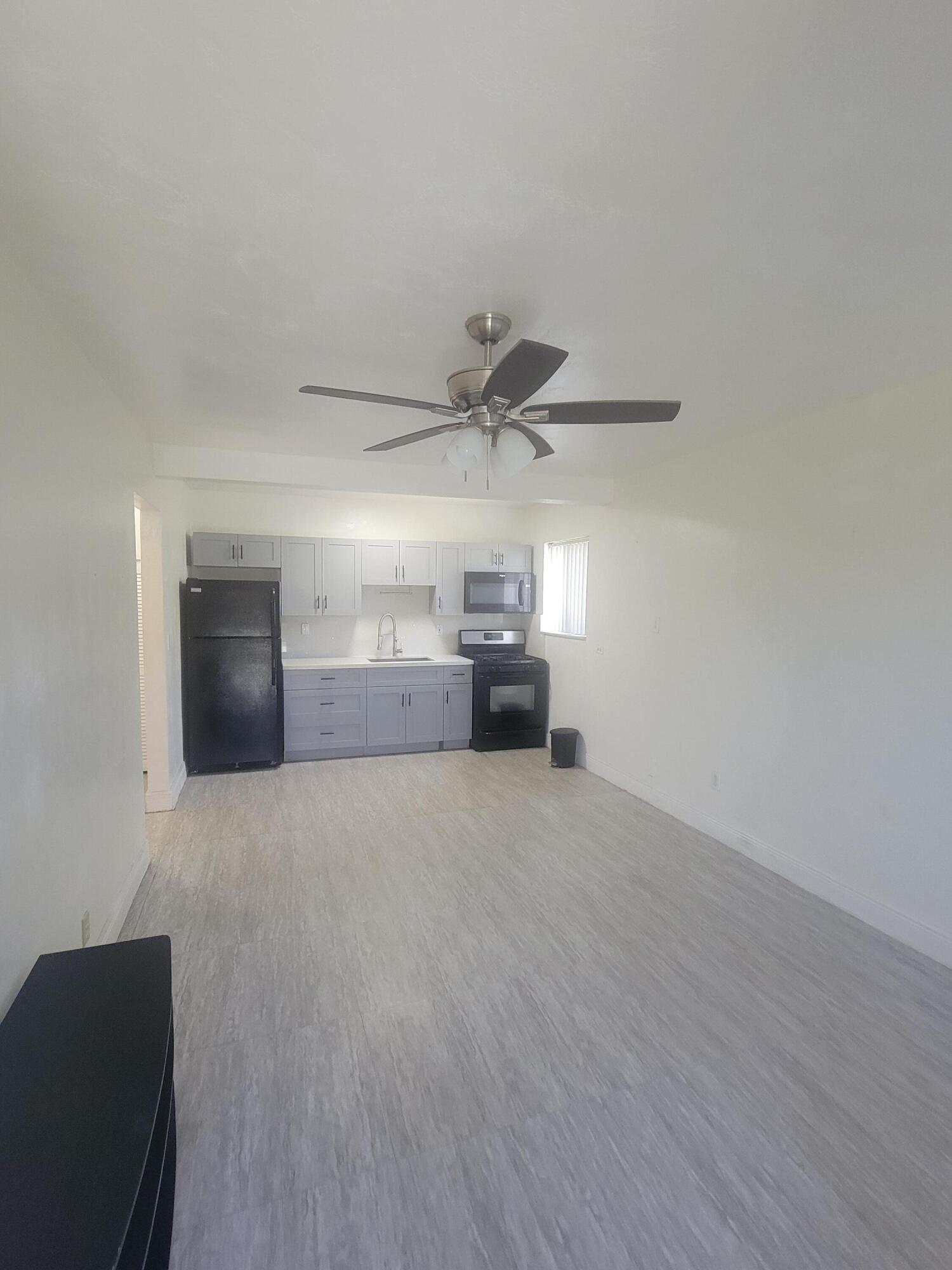 1845 Pembroke Road, Unit 212 Hollywood, FL 33020 - Photo 4 of 10 a furnished livingroom with a ceiling fan and window