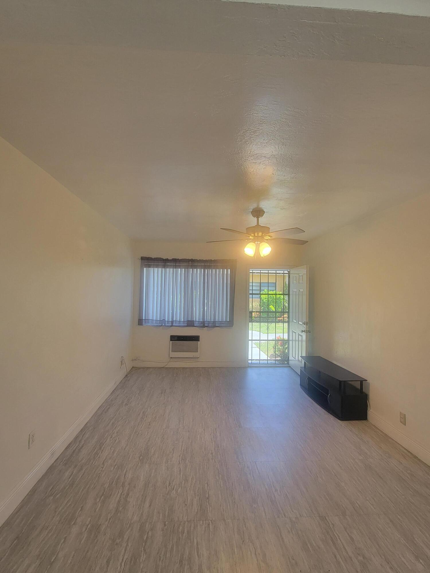 1845 Pembroke Road, Unit 212 Hollywood, FL 33020 - Photo 6 of 10 a view of a room with wooden floor and a window