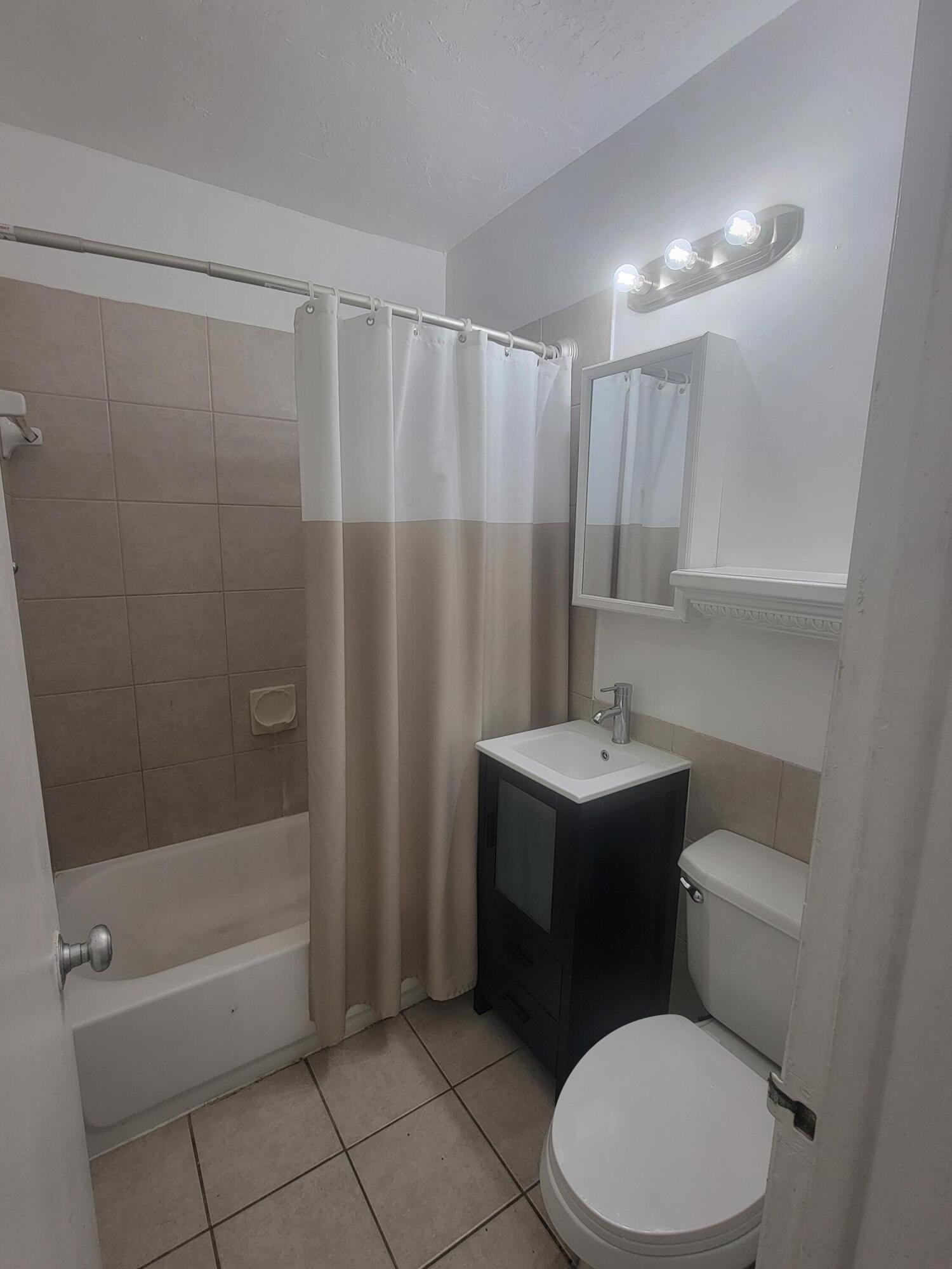 1845 Pembroke Road, Unit 212 Hollywood, FL 33020 - Photo 10 of 10 a bathroom with a sink a toilet and shower