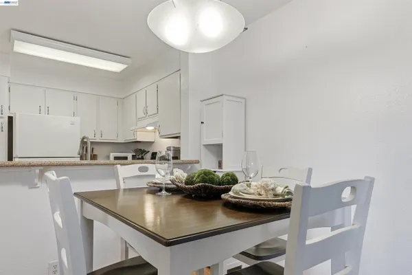 a kitchen with kitchen island stainless steel appliances a sink and cabinets