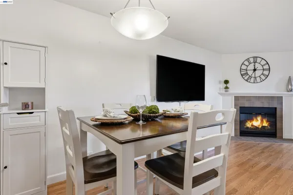 a kitchen with a stove and a flat screen tv