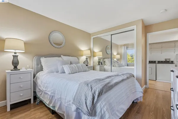 a bedroom with a bed and wooden floor