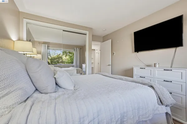 a bedroom with a bed and a flat screen tv