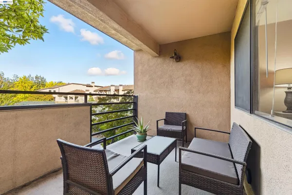 a view of a chairs and table in a balcony