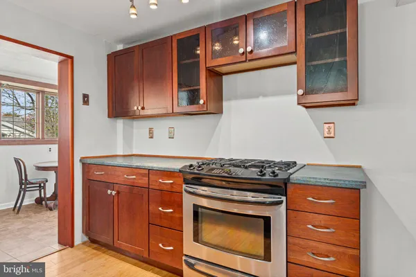 a kitchen with stainless steel appliances granite countertop a stove and a microwave