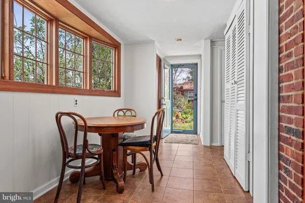 a view of a dining room with furniture and window