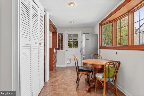 a dining room with furniture and window