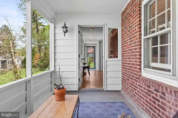 a view of front door and porch with wooden floor