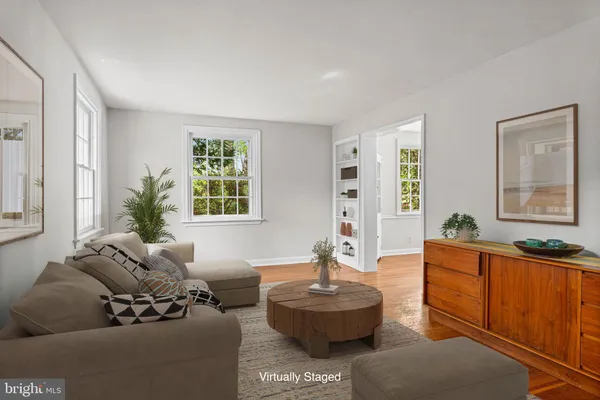 a living room with fireplace furniture and a window