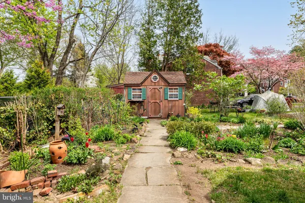 a front view of a house with a yard and tree s