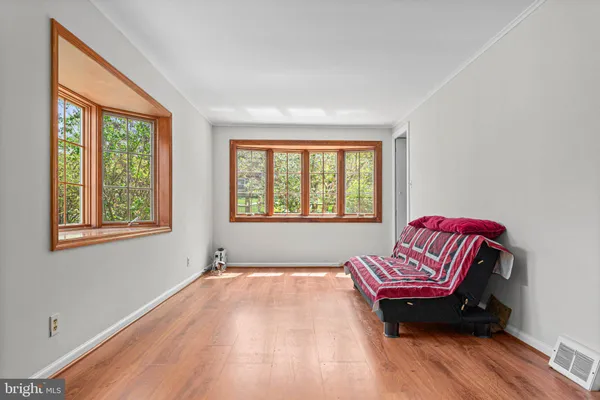 a room with a bed and wooden floor