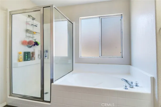 a bathroom with a bathtub and a shower