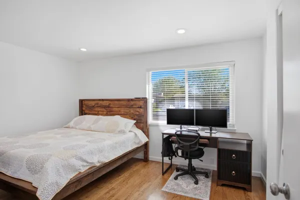 a bedroom with a workspace