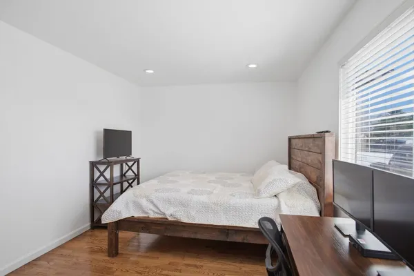 a bedroom with a bed and a desk