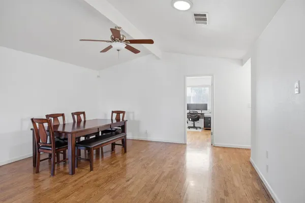 a view of a dining room with furniture and wooden floor