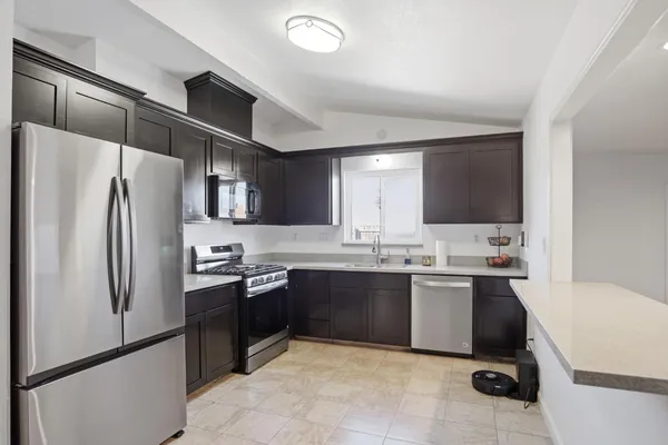 a large kitchen with cabinets and stainless steel appliances