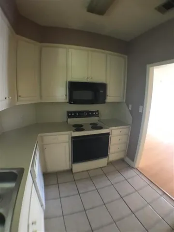 a kitchen with a stove a sink and a microwave