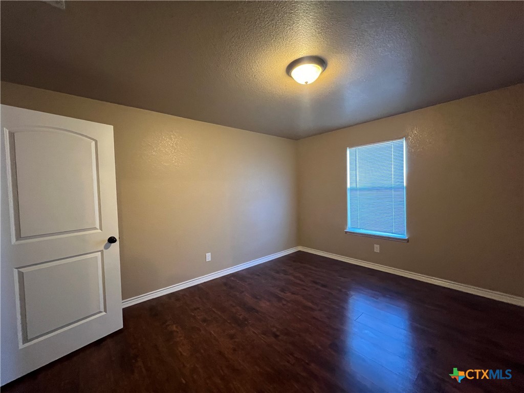 1105 Grace Point Drive Killeen, TX 76549 - Photo 15 of 25 an empty room with wooden floor and windows
