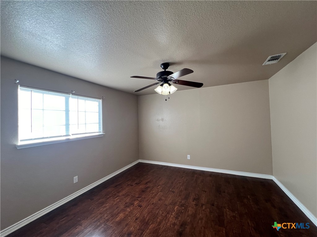 1105 Grace Point Drive Killeen, TX 76549 - Photo 24 of 25 a view of a big room with wooden floor and windows in a room
