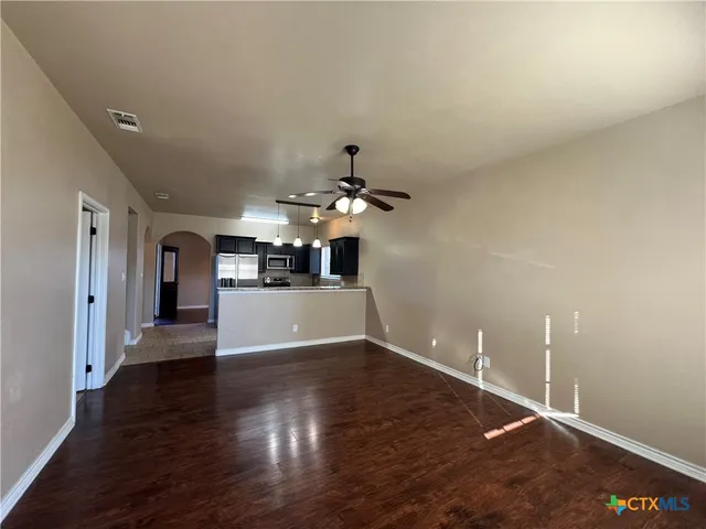 a view of a livingroom with wooden floor and chandelier
