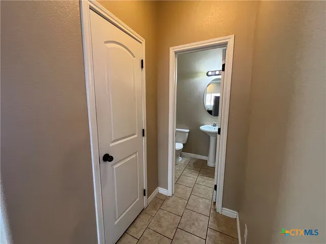 a bathroom with a granite countertop mirror and a toilet