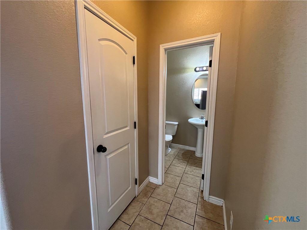 1105 Grace Point Drive Killeen, TX 76549 - Photo 8 of 25 a bathroom with a granite countertop mirror and a toilet