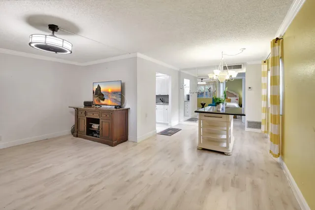a living room with furniture and a kitchen