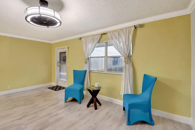a view of a livingroom with furniture and a window