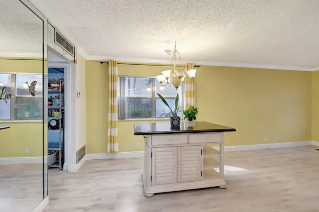 a hallway with a table and chairs