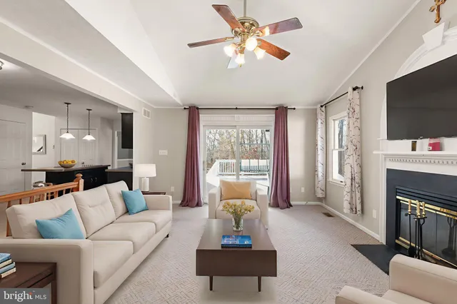 a living room with furniture fireplace and flat screen tv