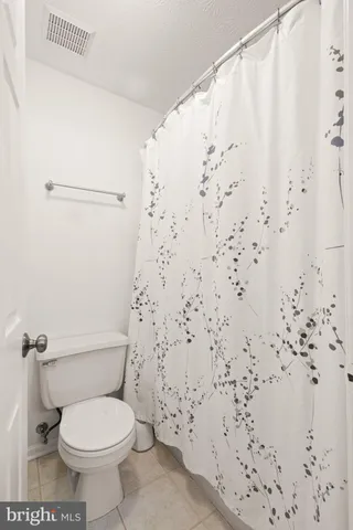 a view of a room with a ceiling fan