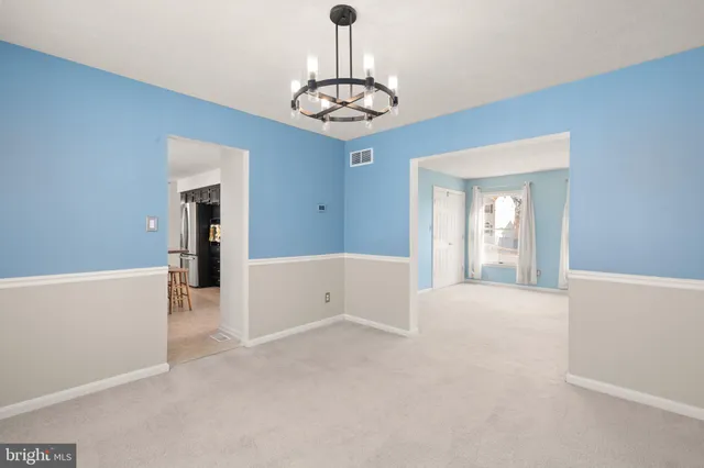 a kitchen with stainless steel appliances granite countertop a sink a stove and a wooden cabinets