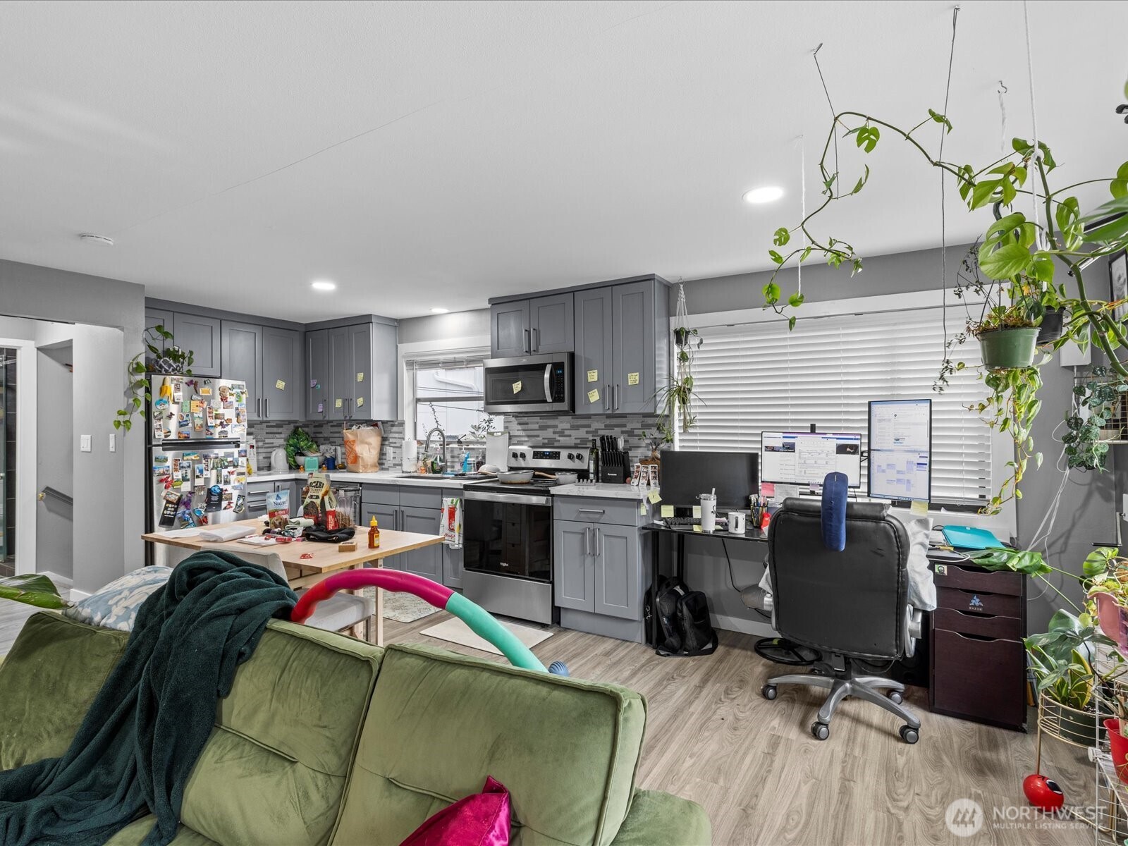 7138 47th Avenue Southwest Seattle, WA 98136 - Photo 5 of 20 a living room with stainless steel appliances furniture a dining table and chairs